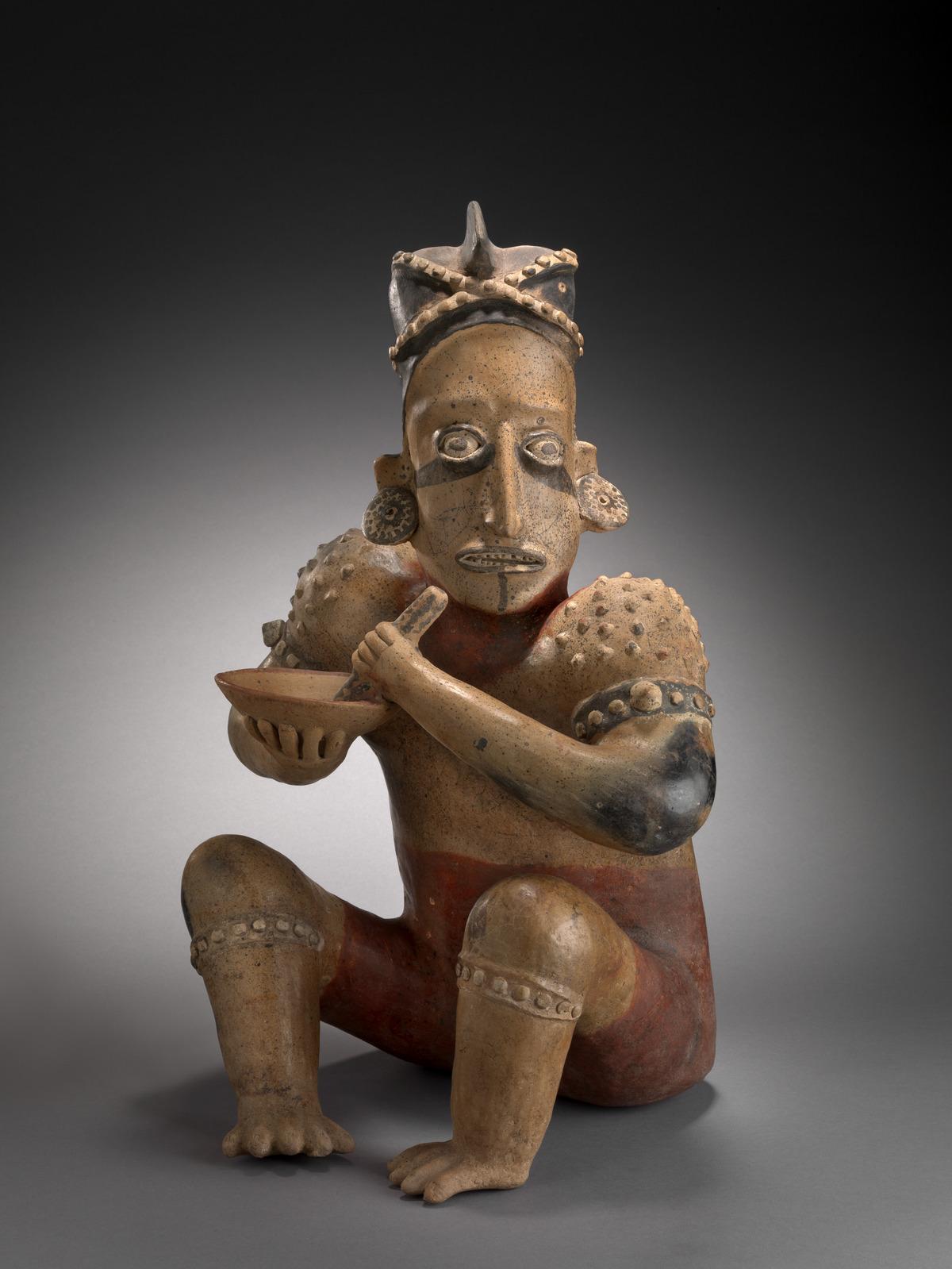 beeldje van zittende man