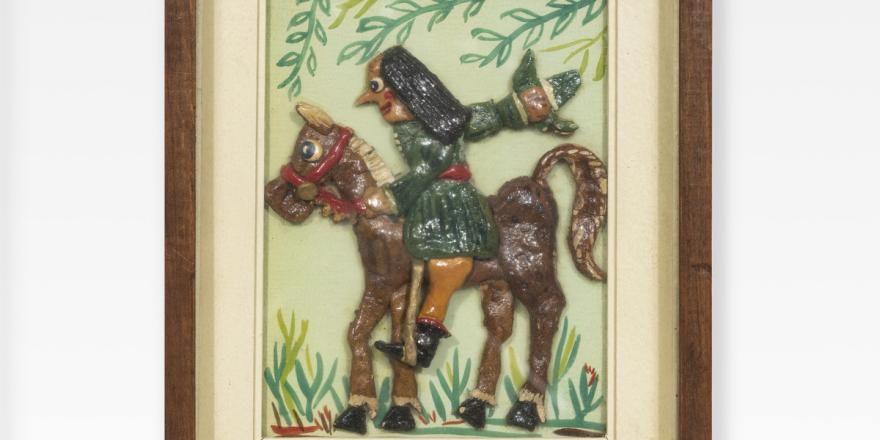 Ingelijst onder glas, een geboetseerd tafereel uit de Ballade van Heer Halewijn: Halewijn op paard