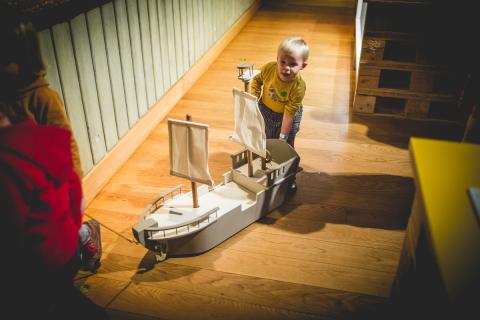 kind met speelgoedboot