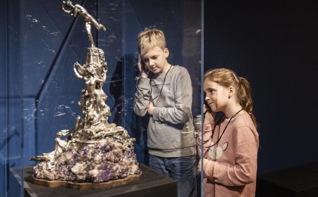 2 kinderen staan voor een mini-standbeeld